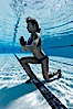 Athletic young girl underwater, performing isometric exercises. Image #27059