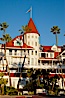 Hotel del Coronado, known affectionately as the Hotel Del. It was once the largest hotel in the world, and is one of the few remaining wooden Victorian beach resorts. It sits on the beach on Coronado Island, seen here with downtown San Diego in the distance. It is widely considered to be one of Americas most beautiful and classic hotels. Built in 1888, it was designated a National Historic Landmark in 1977. San Diego, California, USA. Image #27106