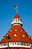 Hotel del Coronado, known affectionately as the Hotel Del. It was once the largest hotel in the world, and is one of the few remaining wooden Victorian beach resorts. It sits on the beach on Coronado Island, seen here with downtown San Diego in the distance. It is widely considered to be one of Americas most beautiful and classic hotels. Built in 1888, it was designated a National Historic Landmark in 1977. San Diego, California, USA. Image #27107