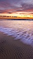 Sunset and incoming surf, gorgeous colors in the sky and on the ocean at dusk, the incoming waves are blurred in this long exposure. Carlsbad, California, USA. Image #27155
