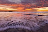 Sunset and incoming surf, gorgeous colors in the sky and on the ocean at dusk, the incoming waves are blurred in this long exposure. Carlsbad, California, USA. Image #27157