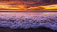 Sunset and incoming surf, gorgeous colors in the sky and on the ocean at dusk, the incoming waves are blurred in this long exposure. Carlsbad, California, USA. Image #27158