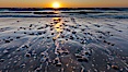 Sunset and incoming surf, gorgeous colors in the sky and on the ocean at dusk, the incoming waves are blurred in this long exposure. Carlsbad, California, USA. Image #27185