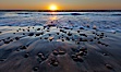 Sunset and incoming surf, gorgeous colors in the sky and on the ocean at dusk, the incoming waves are blurred in this long exposure. Carlsbad, California, USA. Image #27186