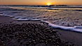 Sunset and incoming surf, gorgeous colors in the sky and on the ocean at dusk, the incoming waves are blurred in this long exposure. Carlsbad, California, USA. Image #27187