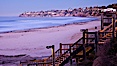 The Crystal Pier and Pacific Ocean at sunrise, dawn, waves blur as they crash upon the sand.  Crystal Pier, 872 feet long and built in 1925, extends out into the Pacific Ocean from the town of Pacific Beach. Pacific Beach, California, USA. Image #27242