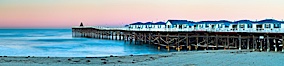 The Crystal Pier and Pacific Ocean at sunrise, dawn, waves blur as they crash upon the sand.  Crystal Pier, 872 feet long and built in 1925, extends out into the Pacific Ocean from the town of Pacific Beach. Pacific Beach, California, USA. Image #27246
