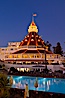 Hotel del Coronado with holiday Christmas night lights, known affectionately as the Hotel Del. It was once the largest hotel in the world, and is one of the few remaining wooden Victorian beach resorts. It sits on the beach on Coronado Island, seen here with downtown San Diego in the distance. It is widely considered to be one of Americas most beautiful and classic hotels. Built in 1888, it was designated a National Historic Landmark in 1977. San Diego, California, USA. Image #27396