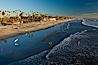 The coast of Oceanside California, waves and surfers, beach houses, just before sunset, winter, looking south. Oceanside Pier, Oceanside, California, USA. Image #27598