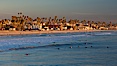 The coast of Oceanside California, waves and surfers, beach houses, just before sunset, winter, looking south. Oceanside Pier, Oceanside, California, USA. Image #27606