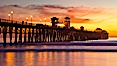 Oceanside Pier at sunset, clouds with a brilliant sky at dusk, the lights on the pier are lit. Oceanside Pier, Oceanside, California, USA. Image #27614