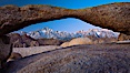 Mount Whitney and Lone Pine Peak are framed by Lathe Arch in the Alabama Hills at sunrise, California. Alabama Hills Recreational Area, California, USA. Image #27624