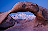 Mobius Arch at sunrise, framing snow dusted Lone Pine Peak and the Sierra Nevada Range in the background. Also known as Galen's Arch, Mobius Arch is found in the Alabama Hills Recreational Area near Lone Pine. Alabama Hills Recreational Area, California, USA. Image #27627