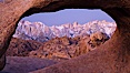 Mobius Arch at sunrise, framing snow dusted Lone Pine Peak and the Sierra Nevada Range in the background. Also known as Galen's Arch, Mobius Arch is found in the Alabama Hills Recreational Area near Lone Pine. Alabama Hills Recreational Area, California, USA. Image #27628