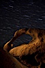 Mobius Arch in the Alabama Hills, seen here at night with swirling star trails formed in the sky above due to a long time exposure. Alabama Hills Recreational Area, California, USA. Image #27674