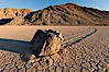 Sailing stone on the Racetrack Playa. The sliding rocks, or sailing stones, move across the mud flats of the Racetrack Playa, leaving trails behind in the mud. The explanation for their movement is not known with certainty, but many believe wind pushes the rocks over wet and perhaps icy mud in winter. Racetrack Playa, Death Valley National Park, California, USA. Image #27689