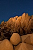 Boulders and stars, moonlight in Joshua Tree National Park. The moon gently lights unusual boulder formations at Jumbo Rocks in Joshua Tree National Park, California. Joshua Tree National Park, California, USA. Image #27716