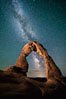 Milky Way arches over Delicate Arch, as stars cover the night sky. Arches National Park, Utah, USA. Image #27850