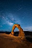 Milky Way and Shooting Star over Delicate Arch, as stars cover the night sky. Arches National Park, Utah, USA. Image #27854