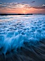 Sunset and incoming surf, gorgeous colors in the sky and on the ocean at dusk, the incoming waves are blurred in this long exposure. Carlsbad, California, USA. Image #27879