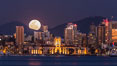 Full Moon rising over San Diego City Skyline, viewed from Harbor Island. Mount San Miguel is to the right, Lyons Peak to the left, in the distance. California, USA. Image #29121