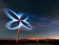 Stars rise above the Ocotillo Wind Turbine power generation facility, with a flashlight illuminating the turning turbine blades. California, USA. Image #30227