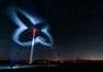 Stars rise above the Ocotillo Wind Turbine power generation facility, with a flashlight illuminating the turning turbine blades. California, USA. Image #30228
