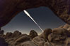 Lunar Eclipse Sequence, the path of the moon through the sky as it progresses from being fully visible (top) to fully eclipsed (middle) to almost fully visible again (bottom), viewed through Arch Rock, April 4 2015. Joshua Tree National Park, California, USA. Image #30713