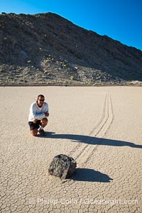 A sliding rock of the Racetrack Playa.  The sliding rocks, or sailing stones, move across the mud flats of the Racetrack Playa, leaving trails behind in the mud.  The explanation for their movement is not known with certainty, but many believe wind pushes the rocks over wet and perhaps icy mud in winter, Death Valley National Park, California