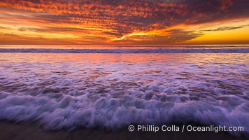 Sunset and incoming surf, gorgeous colors in the sky and on the ocean at dusk, the incoming waves are blurred in this long exposure, Carlsbad, California