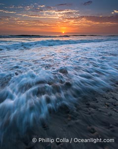 Sunset and incoming surf, gorgeous colors in the sky and on the ocean at dusk, the incoming waves are blurred in this long exposure, Carlsbad, California