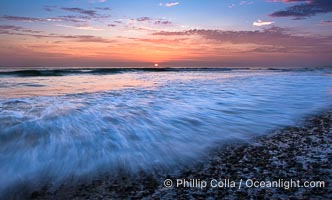 Sunset and incoming surf, gorgeous colors in the sky and on the ocean at dusk, the incoming waves are blurred in this long exposure, Carlsbad, California