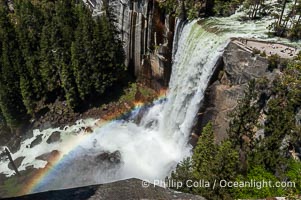 Vernal Falls at peak flow in late spring, hikers visible at precipice, viewed from John Muir Trail, Yosemite National Park, California