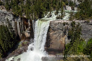 Vernal Falls at peak flow in late spring, hikers visible at precipice, viewed from John Muir Trail, Yosemite National Park, California