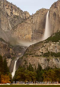 Yosemite Falls by moonlight, viewed from Cooks Meadow. Star trails appear in the night sky. Yosemite Valley, Yosemite National Park, California