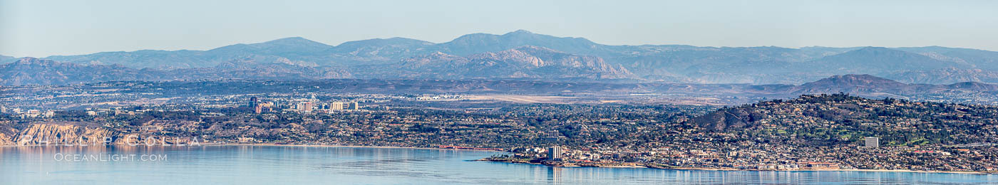 Aerial Panorama of La Jolla, University City, showing (from left) UCSD, University City, Scripps Institution of Oceanography, La Jolla Shores, Point La Jolla, Mount Soledad, in the background some of the mountains to the east of San Diego. The highest peak in the center of the panoram is Cuyamaca Peak (6512') while the rocky peak directly in front of it is El Cajon Mountain (3675')