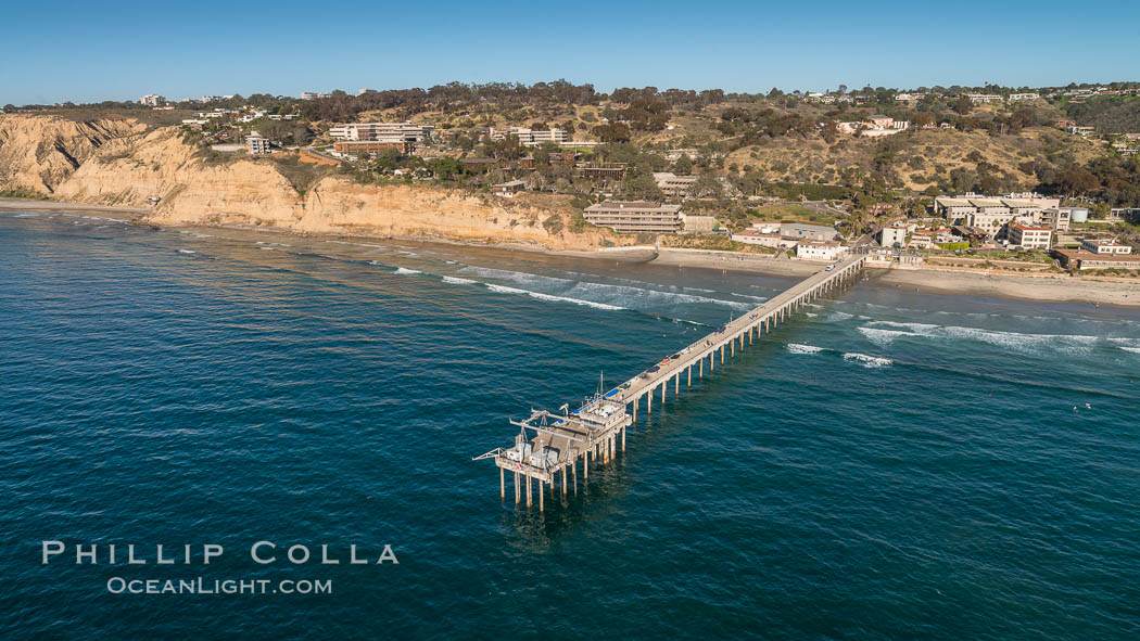 Aerial Photo of Scripps Pier. SIO Pier. The Scripps Institution of Oceanography research pier is 1090 feet long and was built of reinforced concrete in 1988, replacing the original wooden pier built in 1915. The Scripps Pier is home to a variety of sensing equipment above and below water that collects various oceanographic data. The Scripps research diving facility is located at the foot of the pier. Fresh seawater is pumped from the pier to the many tanks and facilities of SIO, including the Birch Aquarium. The Scripps Pier is named in honor of Ellen Browning Scripps, the most significant donor and benefactor of the Institution., natural history stock photograph, photo id 30738