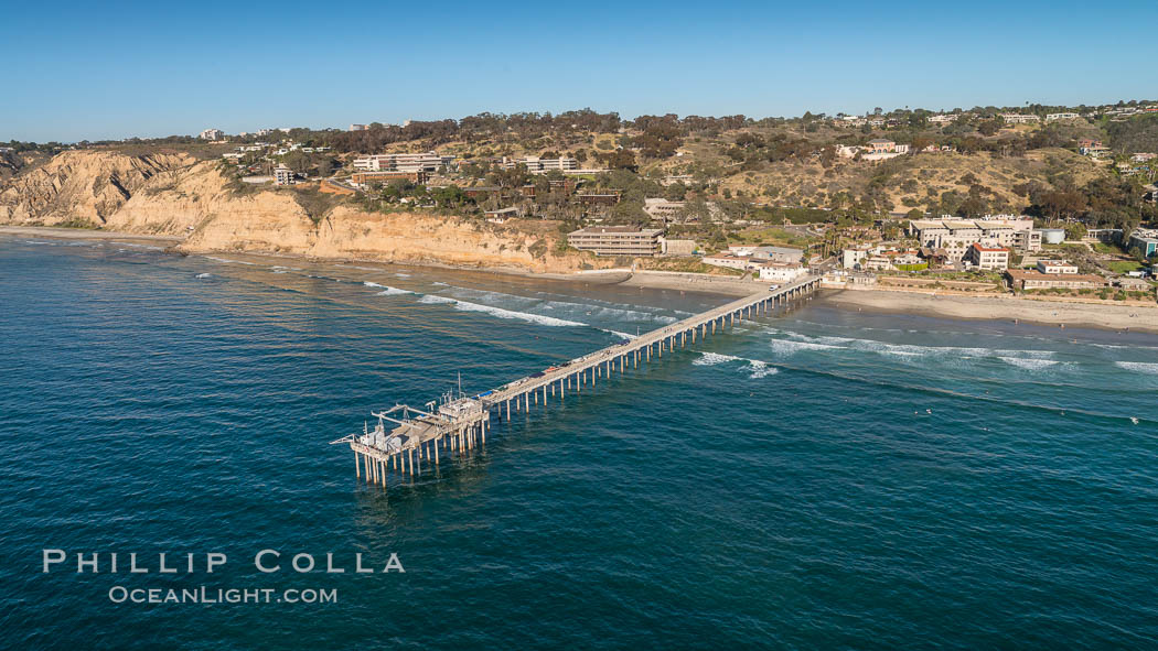 Aerial Photo of Scripps Pier. SIO Pier. The Scripps Institution of Oceanography research pier is 1090 feet long and was built of reinforced concrete in 1988, replacing the original wooden pier built in 1915. The Scripps Pier is home to a variety of sensing equipment above and below water that collects various oceanographic data. The Scripps research diving facility is located at the foot of the pier. Fresh seawater is pumped from the pier to the many tanks and facilities of SIO, including the Birch Aquarium. The Scripps Pier is named in honor of Ellen Browning Scripps, the most significant donor and benefactor of the Institution., natural history stock photograph, photo id 30739