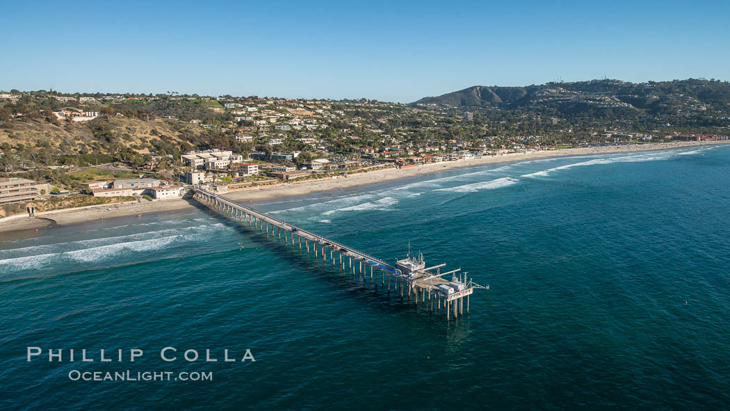 Aerial Photo of Scripps Pier. SIO Pier. The Scripps Institution of Oceanography research pier is 1090 feet long and was built of reinforced concrete in 1988, replacing the original wooden pier built in 1915. The Scripps Pier is home to a variety of sensing equipment above and below water that collects various oceanographic data. The Scripps research diving facility is located at the foot of the pier. Fresh seawater is pumped from the pier to the many tanks and facilities of SIO, including the Birch Aquarium. The Scripps Pier is named in honor of Ellen Browning Scripps, the most significant donor and benefactor of the Institution., natural history stock photograph, photo id 30737