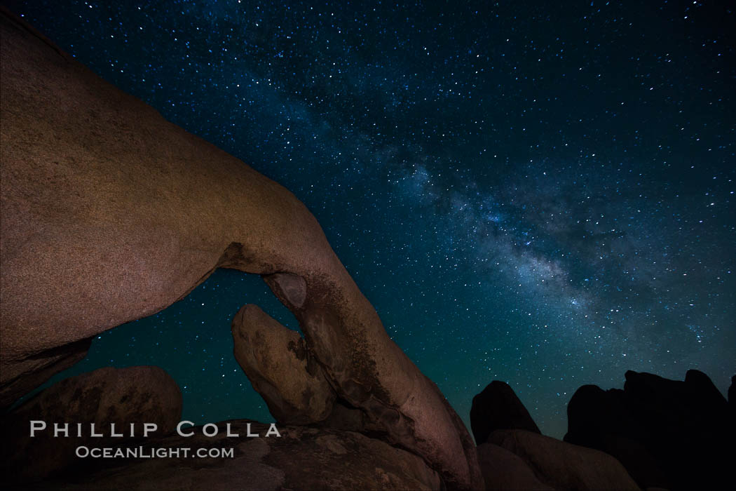 The Milky Way galaxy arcs over Arch Rock on a clear evening in Joshua Tree National Park. California, USA, natural history stock photograph, photo id 27800