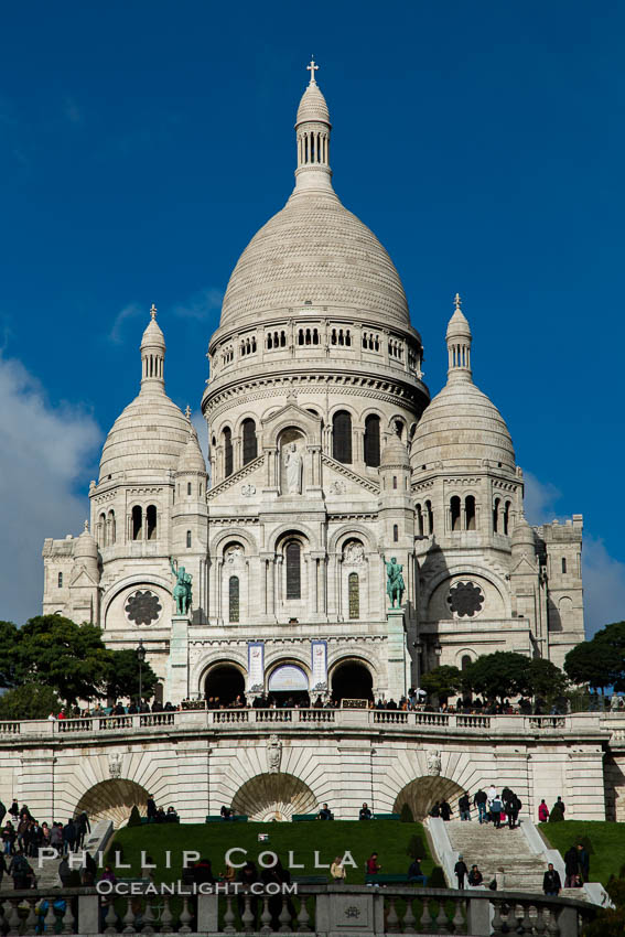 Sacre-Coeur Basilica.  The Basilica of the Sacred Heart of Paris, commonly known as Sacre-Coeur Basilica, is a Roman Catholic church and minor basilica, dedicated to the Sacred Heart of Jesus, in Paris, France. A popular landmark, the basilica is located at the summit of the butte Montmartre, the highest point in the city. Basilique du Sacre-Coeur, natural history stock photograph, photo id 28153