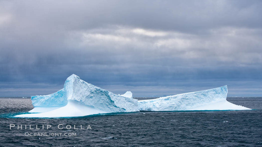 Iceberg, ocean, light and clouds.  Light plays over icebergs and the ocean near Coronation Island