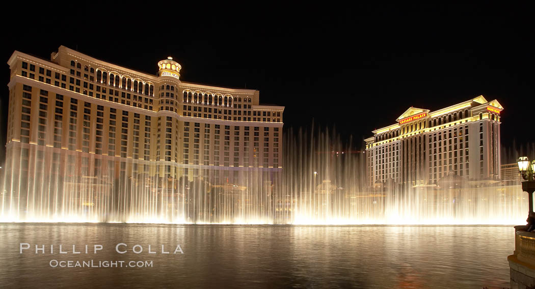 The Bellagio Hotel (left) and Caesar's Palace (right), seen behind the Bellagio fountains, at night.  The Bellagio Hotel fountains are one of the most popular attractions in Las Vegas, showing every half hour or so throughout the day, choreographed to famous Hollywood music. Nevada, USA, natural history stock photograph, photo id 20576
