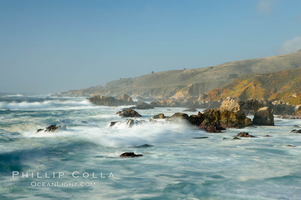 Waves blur as they break over the rocky shoreline of Big Sur