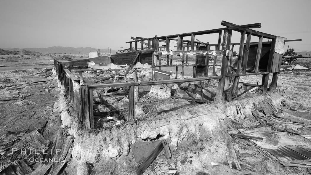 Bombay Beach, lies alongside and below the flood level of the Salton Sea, so that it floods occasionally when the Salton Sea rises.  A part of Bombay Beach is composed of derelict old trailer homes, shacks and wharfs, slowly sinking in the mud and salt. Imperial County, California, USA, natural history stock photograph, photo id 22493