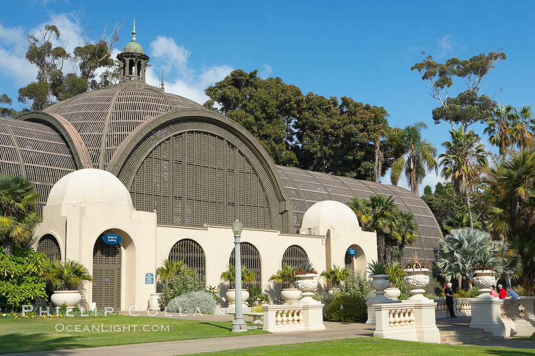 The Botanical Building in Balboa Park, San Diego.  The Botanical Building, at 250 feet long by 75 feet wide and 60 feet tall, was the largest wood lath structure in the world when it was built in 1915 for the Panama-California Exposition. The Botanical Building, located on the Prado, west of the Museum of Art, contains about 2,100 permanent tropical plants along with changing seasonal flowers. The Lily Pond, just south of the Botanical Building, is an eloquent example of the use of reflecting pools to enhance architecture. The 193 by 43 foot pond and smaller companion pool were originally referred to as Las Lagunas de las Flores (The Lakes of the Flowers) and were designed as aquatic gardens. The pools contain exotic water lilies and lotus which bloom spring through fall.  Balboa Park, San Diego. USA, natural history stock photograph, photo id 14579
