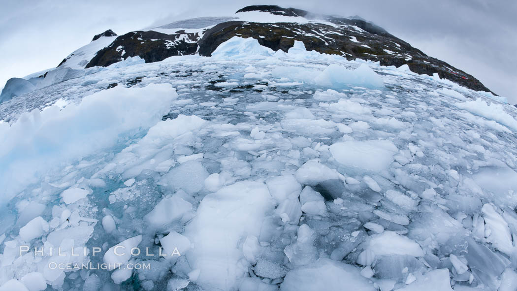 Brash ice and pack ice in Antarctica.  Brash ices fills the ocean waters of Cierva Cove on the Antarctic Peninsula.  The ice is a mix of sea ice that has floated near shore on the tide and chunks of ice that have fallen into the water from nearby land-bound glaciers