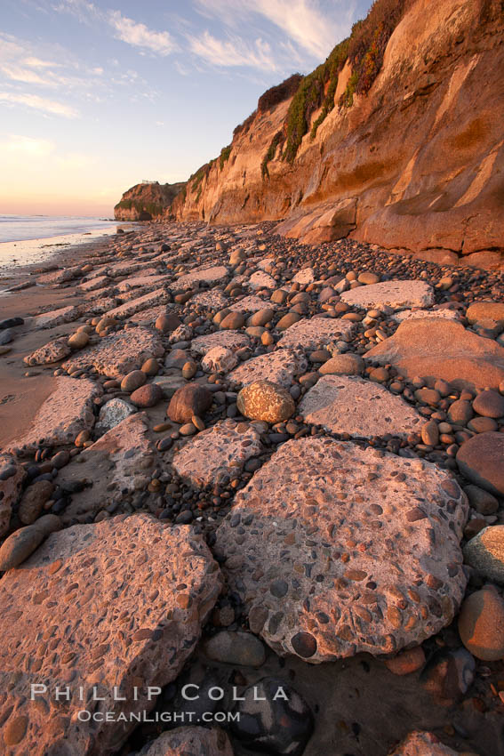 Remains of the old historic "Coast Highway 101", undermined as the bluff upon which it was built eroded away, now broken into pieces of concrete and asphalt blocks and fallen down the sea cliffs, lying on the beach. Carlsbad, California, USA, natural history stock photograph, photo id 22192