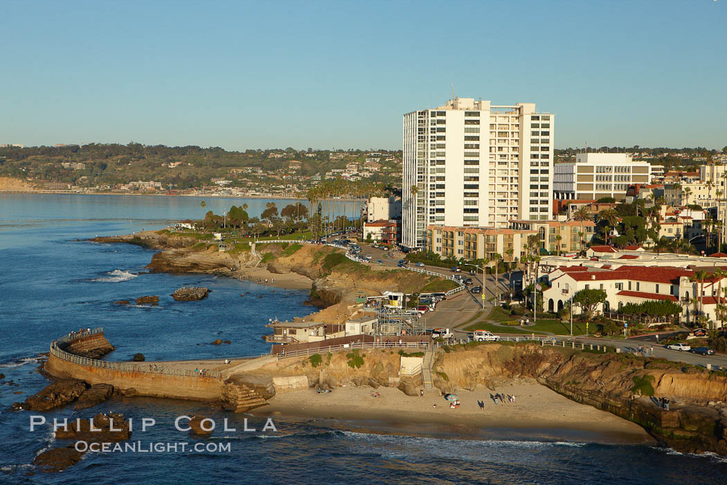 The Children's Pool in La Jolla, also known as Casa Cove, is a small pocket cove protected by a curving seawall, with the rocky coastline and cottages and homes of La Jolla seen behind it. California, USA, natural history stock photograph, photo id 22464