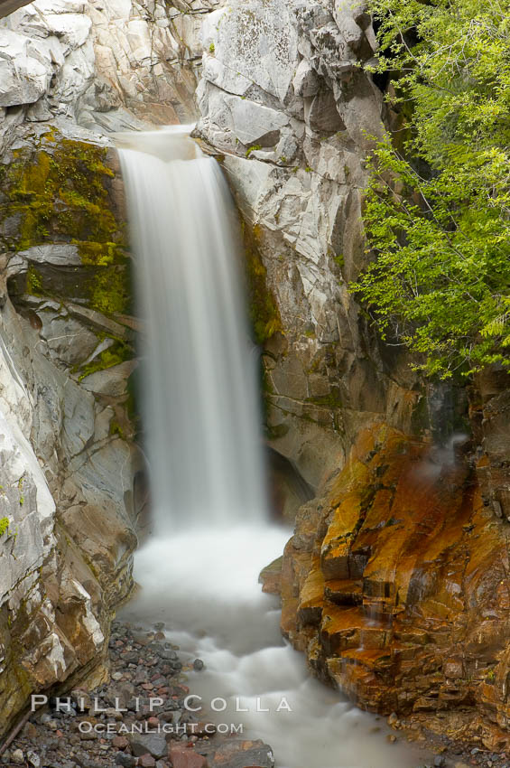 Christine Falls is a 69 foot (21m) waterfall in Mount Rainier.  The lower section of Christine Falls is  known for the bridge that spans across it. Mount Rainier National Park, Washington, USA, natural history stock photograph, photo id 13823